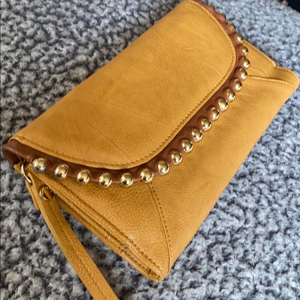 Big Buddha tan faux leather wallet style clutch.